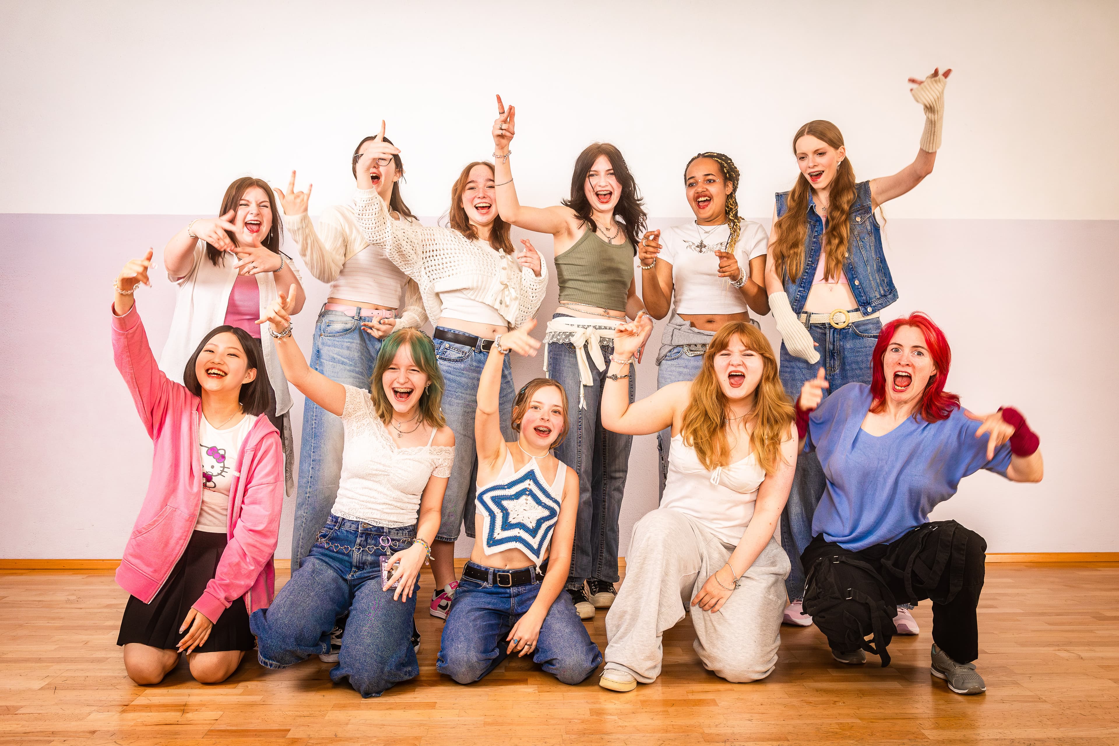 Menschen tanzen miteinander im Tanzkurs und bekommen Anleitung durch eine Tanzlehrerin.